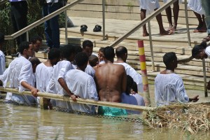 Eritrean men enter the Jordan River on the Israeli side (Seth J. Frantzman)