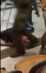 A man with a metal walker protects him perhaps, some tried to help. Screenshot.